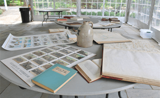 Historical artifacts, books, and documents displayed on tables during UCHS’s May 2021 Show & Tell.