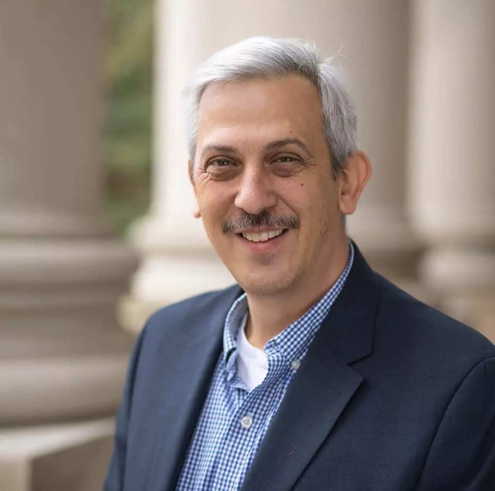 William Frolich in front of Singer Manufacturing Company history exhibit.
