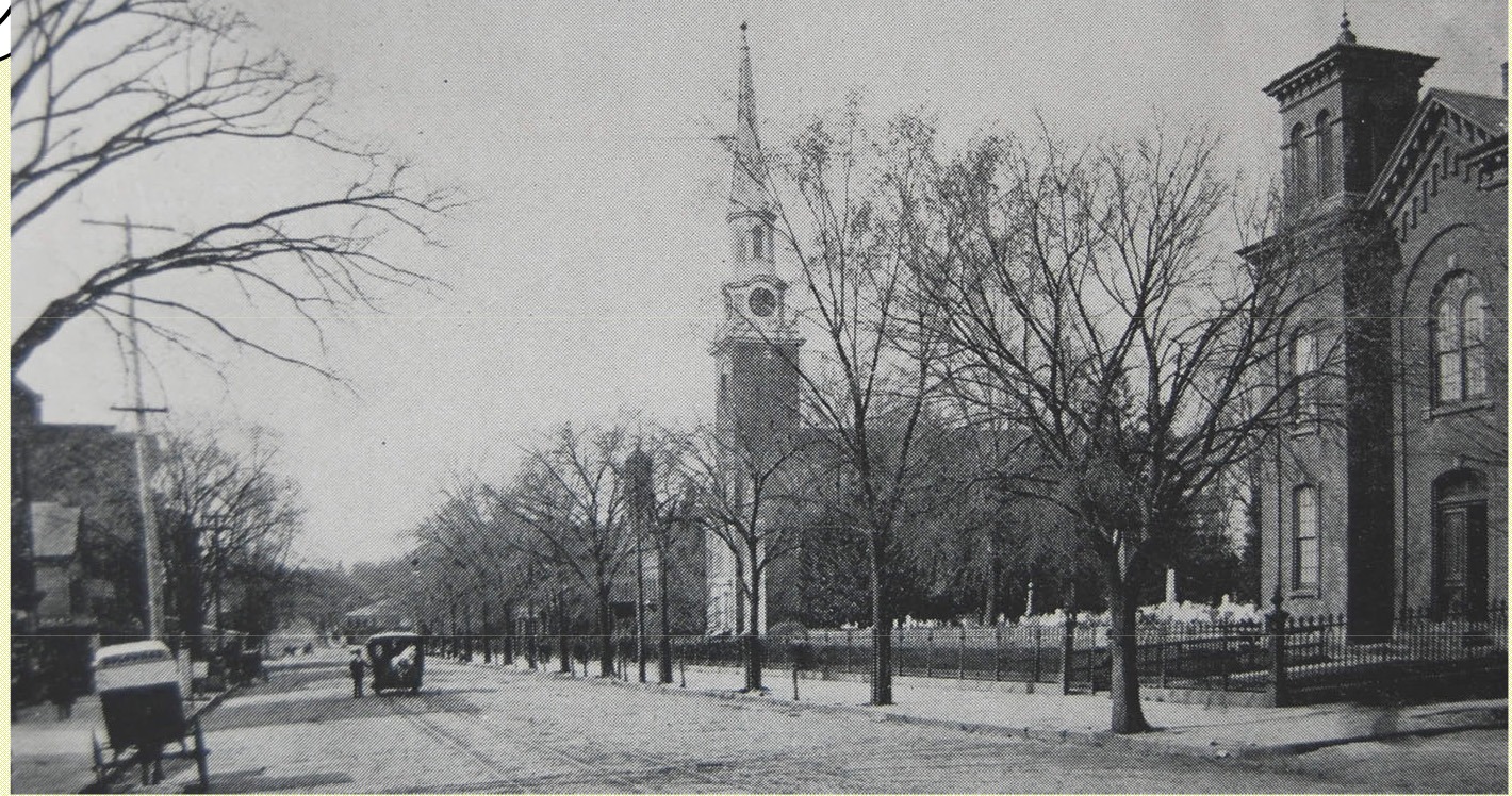 Historic view of Broad Street in Elizabeth, New Jersey circa 1887, showing the First Presbyterian Church, cemetery, and street activity