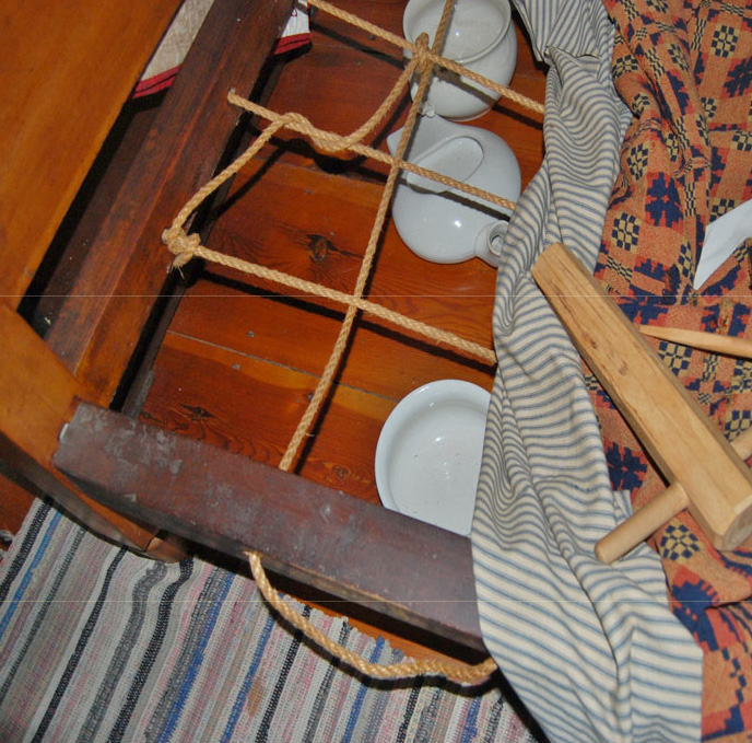 Rope-sprung bed with a bed wrench tool used to tighten the ropes at the Woodruff House in Hillside, New Jersey