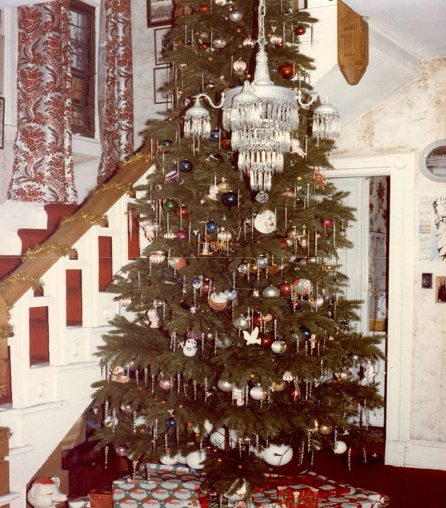 Traditional indoor Christmas tree decorated with ornaments and lights, reflecting “Christmas Long Ago” traditions