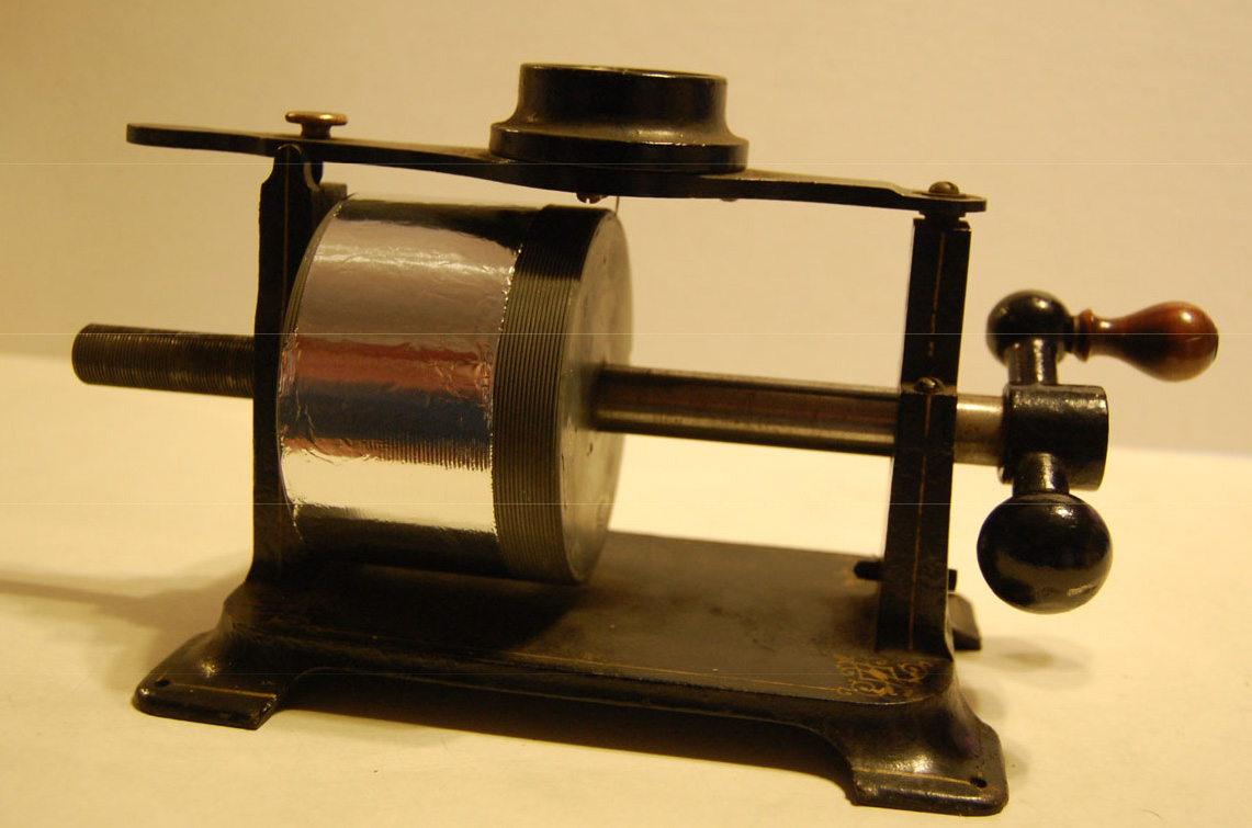 Replica of Thomas Edison’s 1877 phonograph (talking machine) with a cylindrical drum and hand crank.