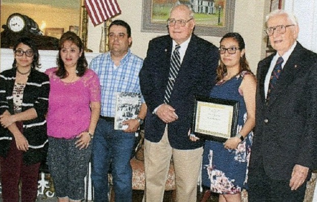 Student award recipients and family members posing with Union County Historical Society officials at the Hanson House.