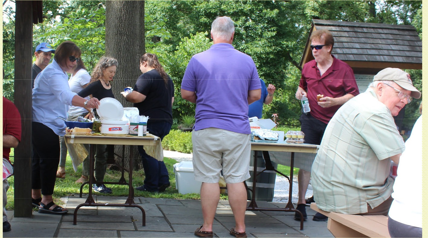 Union County Historical Society members standing near picnic tables at Hanson House