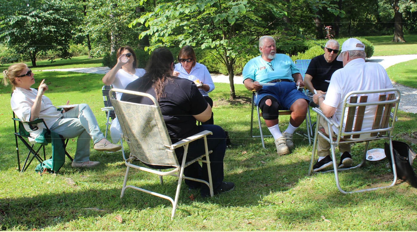 UCHS members seated outdoors during the Hanson House picnic