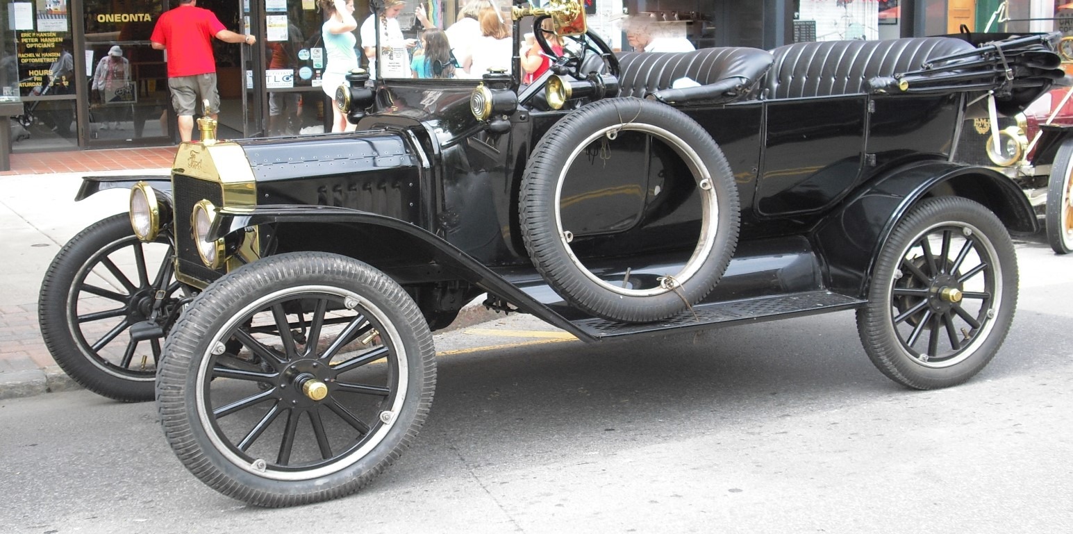 A 1916 black Ford Model T touring car parked on a street.