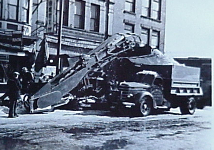 Snow-loader transferring snow into dump trucks on Broad Street in Elizabeth, New Jersey during the 1947 blizzard