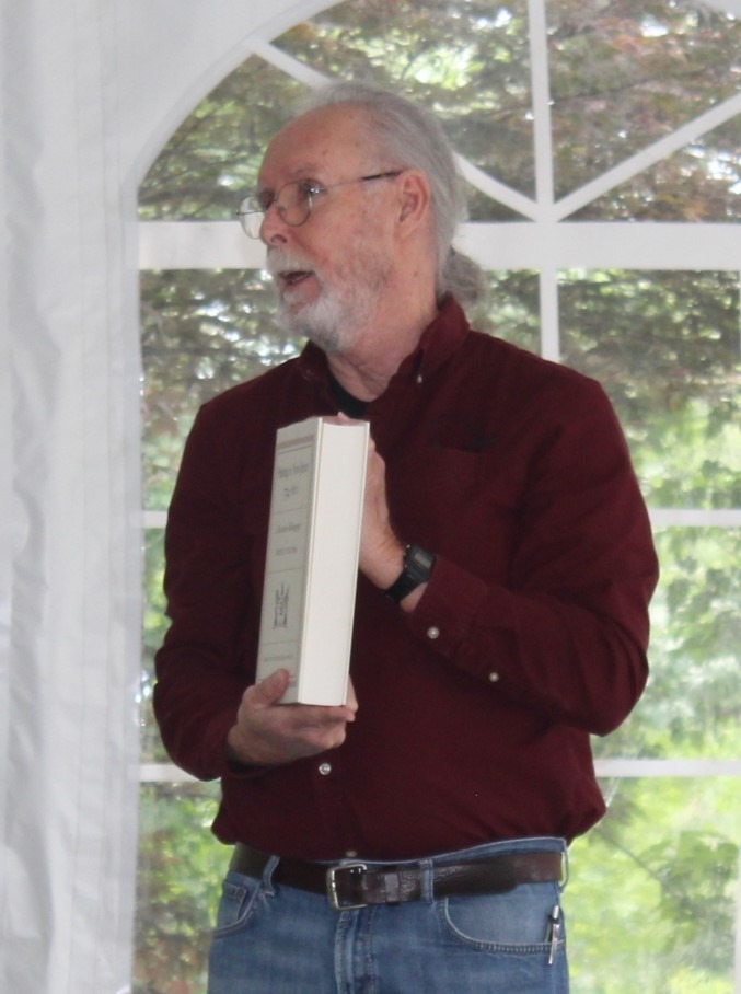 Man presenting a historical book to an audience during the Union County Historical Society meeting