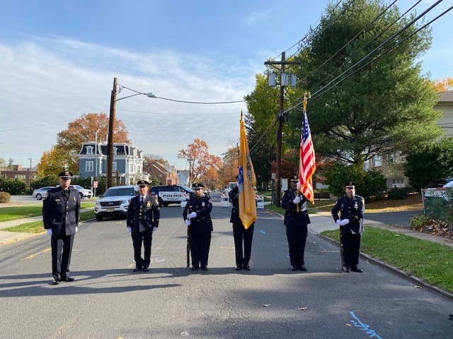 Police color guard carrying flags during the Bill Frolich Way street naming ceremony in Roselle