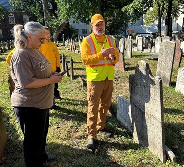 Restorer Jason Harpe demonstrates gravestone cleaning techniques during a community workshop in Elizabeth, New Jersey.