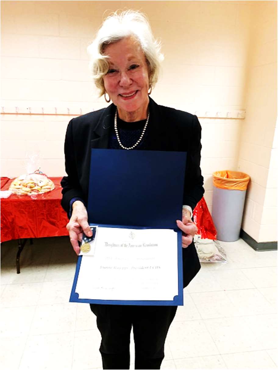 Joanne Rajoppi holding the DAR American 250! Commendation award presented by the Crane’s Ford Chapter of the Daughters of the American Revolution