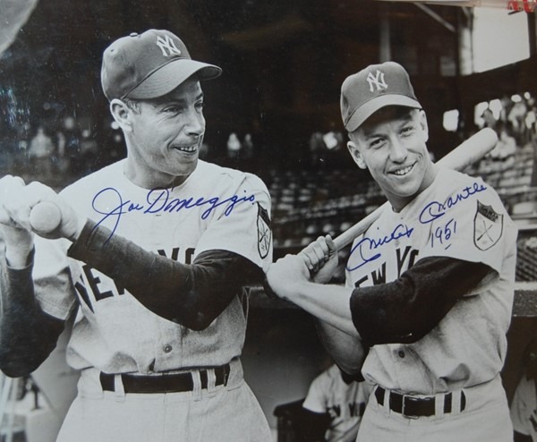 Signed photograph of New York Yankees legends Joe DiMaggio and Mickey Mantle standing together in uniform.